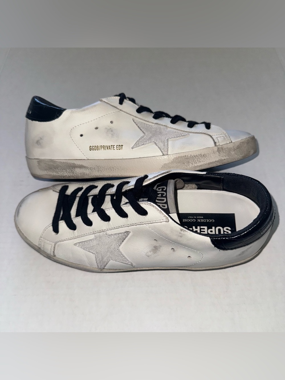 Golden Goose White Sneakers with Black Accents and Gray Star